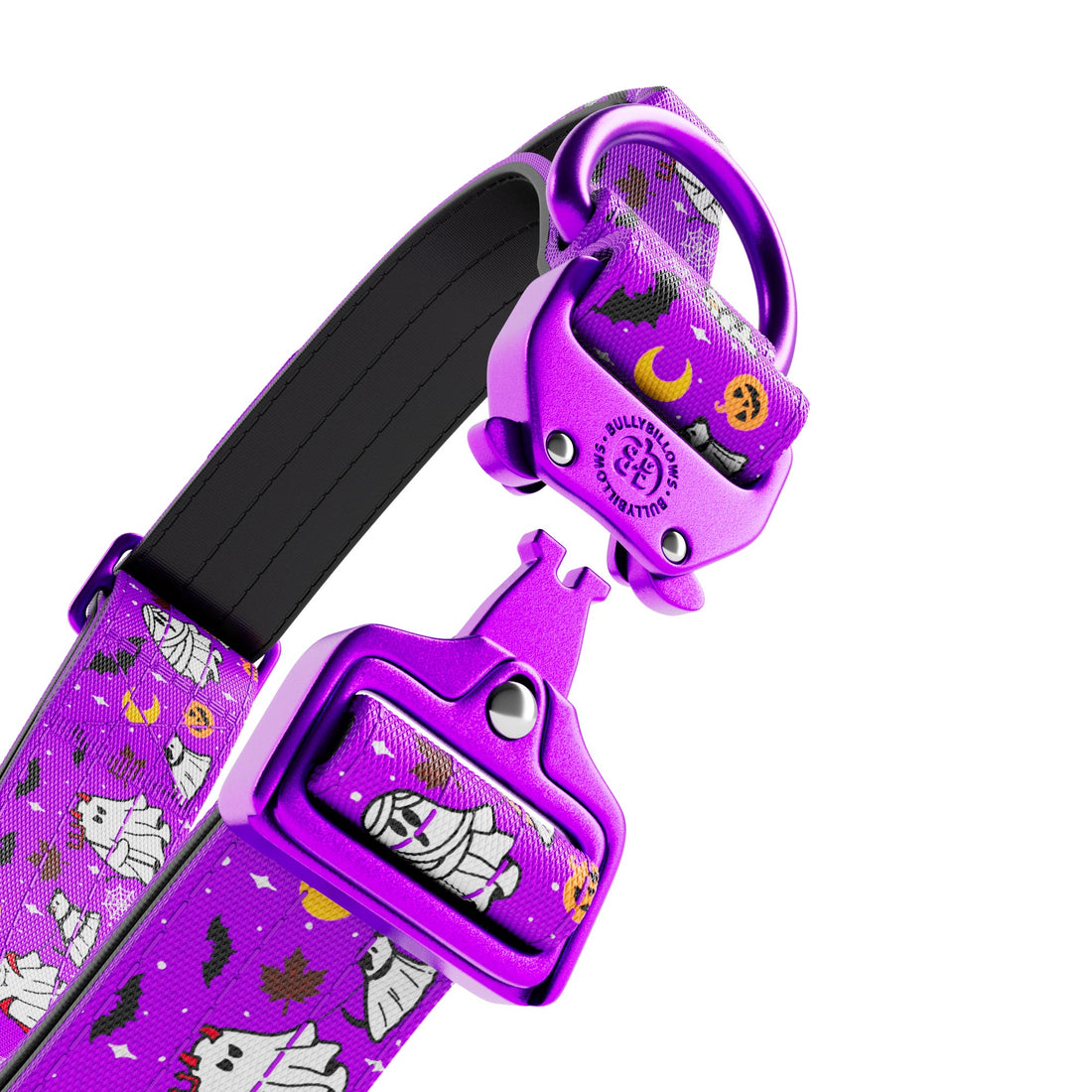 A close-up of a purple pet collar with a Halloween-themed pattern featuring ghosts, mummies, bats, and pumpkins. The collar has a black padded inner lining and a bright purple metal buckle with a matching decorative insert.