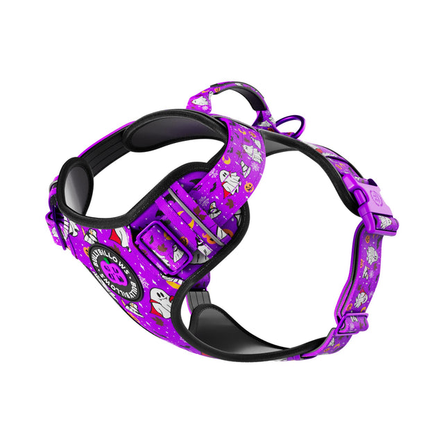 A purple dog harness with a cartoon pattern, featuring black padded interior and adjustable buckles, shown on a plain white background.