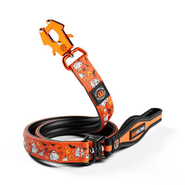 An orange dog leash with a Halloween-themed print of ghosts, bats, and pumpkins, featuring a black handle and a bright orange metal clip, shown on a white background.
